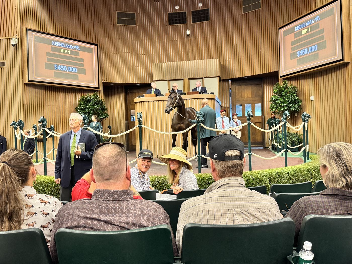 Hip 1 stands in the Keeneland sales ring before a full pavilion as the boards show a bid of $450,000.
